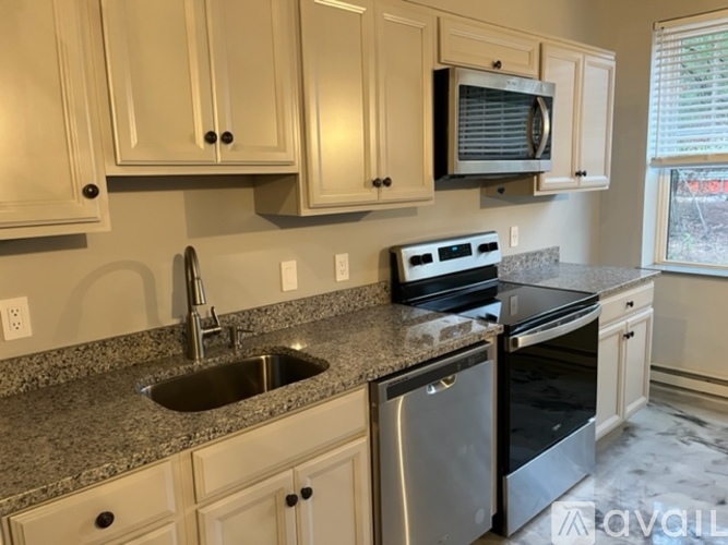 A kitchen with granite countertops and stainless steel appliances.