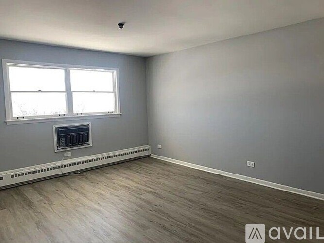 A room with a fireplace and a window.