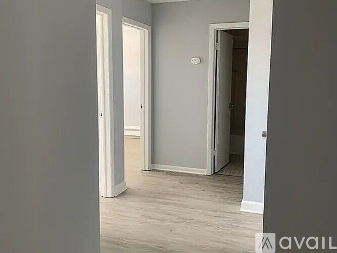 A room with a door and a wall socket.