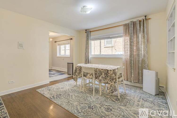 A dining room with a table and chairs set up.