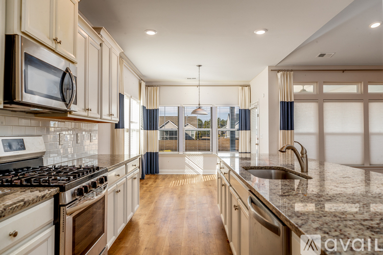A kitchen with a stove top oven and a microwave above it.
