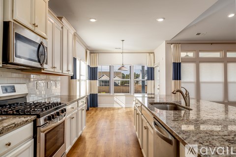 A kitchen with a stove top oven and a microwave above it.
