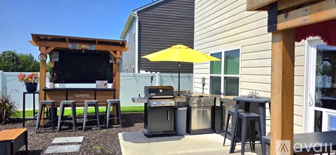 A patio with a bar and stools.