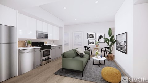 A modern kitchen with a green couch and a coffee table.