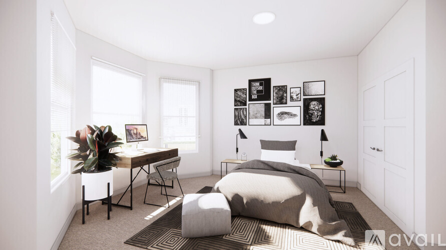 A bedroom with a bed, desk, and chair.