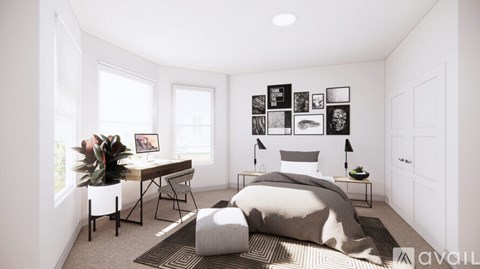 A bedroom with a bed, desk, and chair.