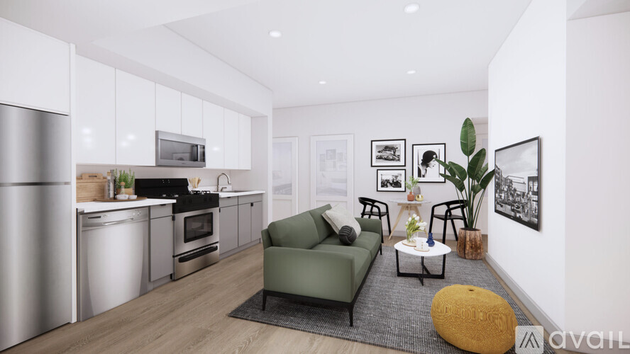 A modern kitchen with a green couch and a coffee table.