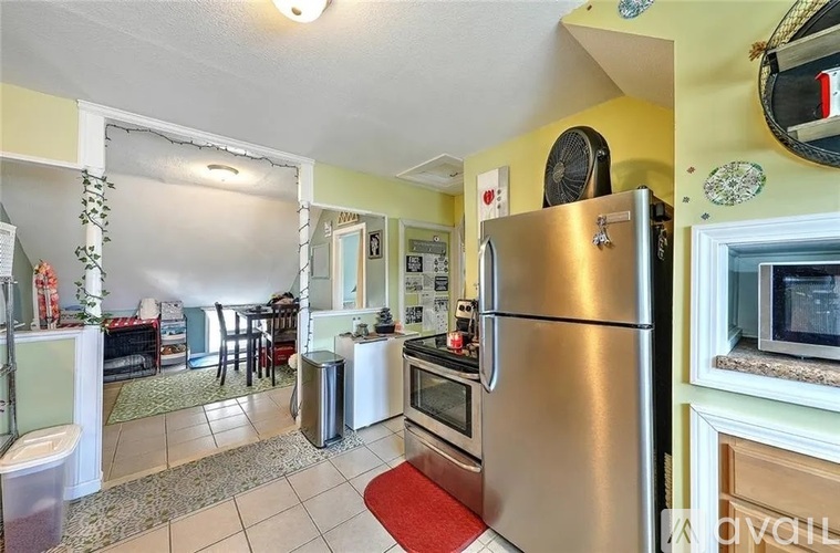 A kitchen with a stainless steel refrigerator and oven.