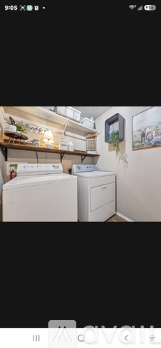 A white washing machine and dryer in a small laundry room.