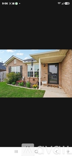 A house with a brown brick exterior and a white door.