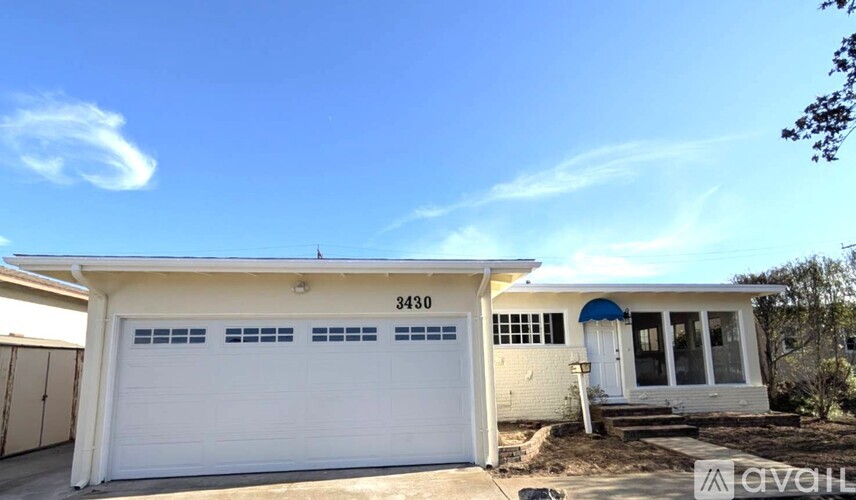 A white garage door with the number 8283 on it.