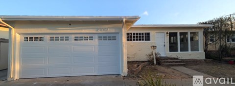 A white garage door with the number 8283 on it.