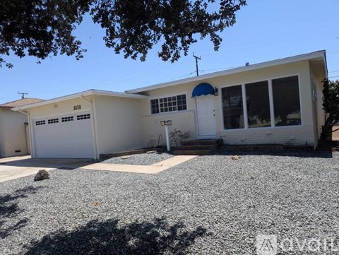 A two-story house with a garage and a driveway.