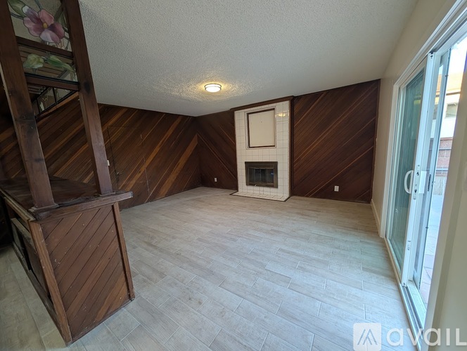 A room with wooden walls and a window.