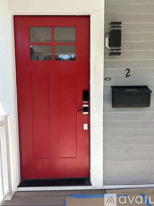 A red door with a mailbox on the wall.