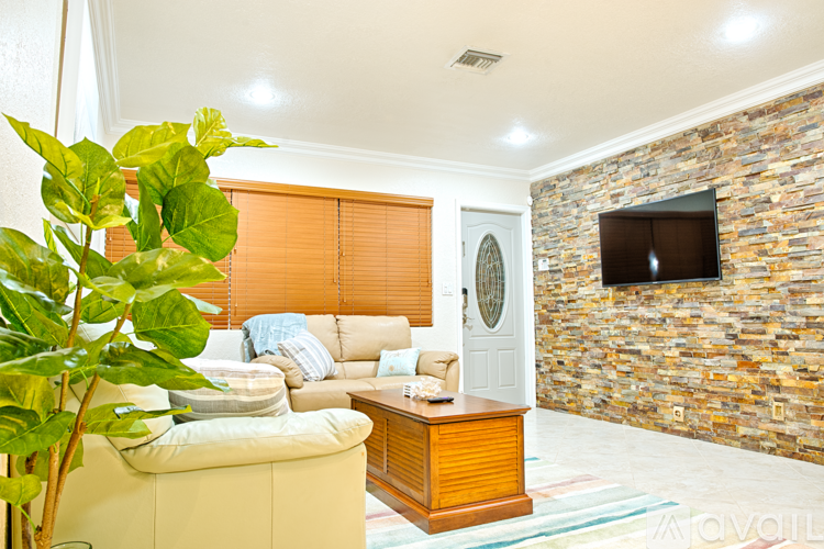 A living room with a stone wall and a couch.