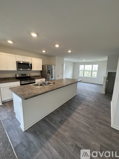 A kitchen with a countertop and a microwave above it.