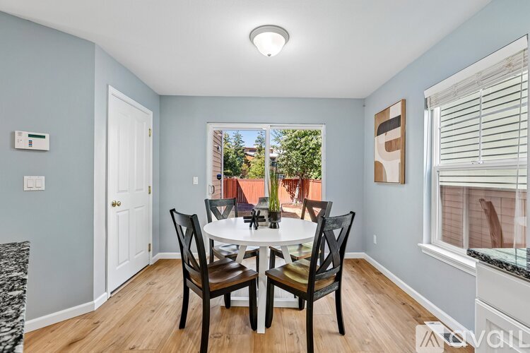 A dining room with a table and chairs.