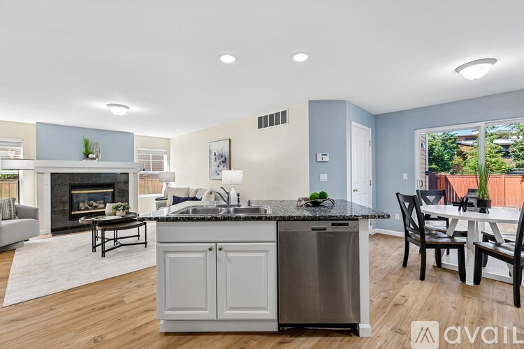 A kitchen with a stove top oven and a dining table.