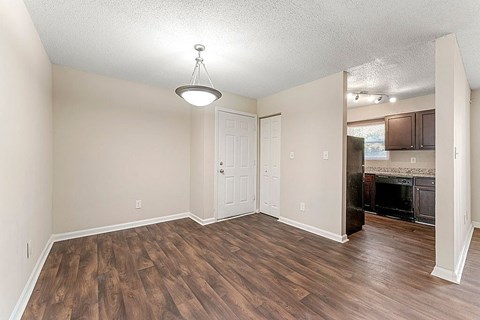 A room with wood flooring and a fireplace.