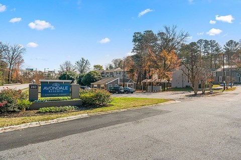 A sign for Avondale Reservoir stands in front of a building.