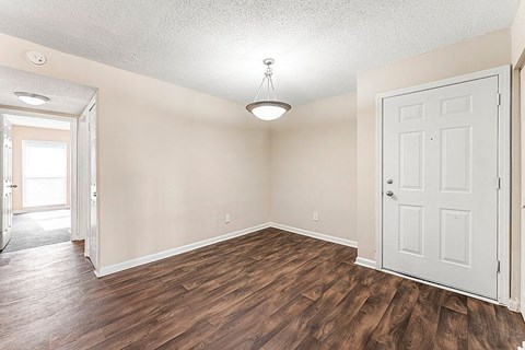 A room with wooden floors and a white door.