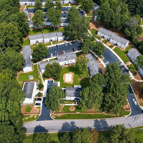 A bird's eye view of a neighborhood with houses and trees.