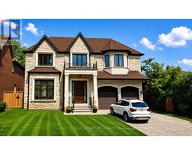 A white car is parked in front of a two-story house.