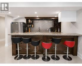 A bar area with black and red stools.