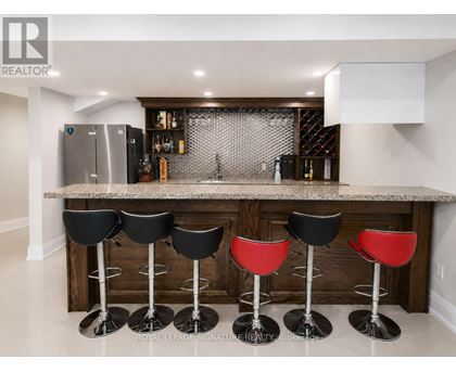 A bar area with black and red stools.