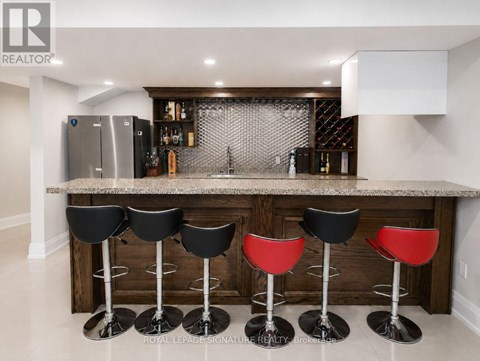 A bar area with black and red stools.