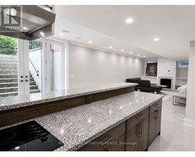 A modern kitchen with a granite countertop and stainless steel appliances.