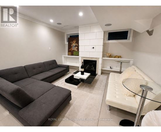 A living room with a grey couch and a white sofa.