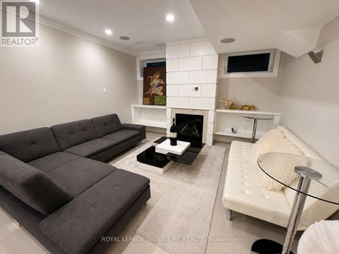 A living room with a grey couch and a white sofa.