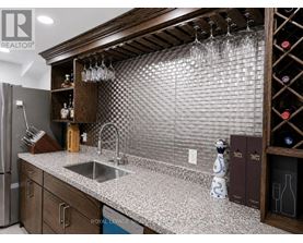 A kitchen with a sink and a refrigerator.