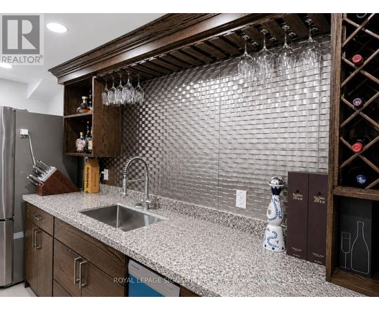 A kitchen with a sink and a refrigerator.