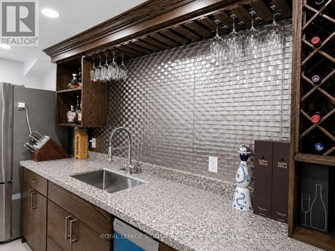 A kitchen with a sink and a refrigerator.