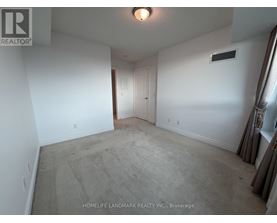 A room with a carpet floor and a white wall.