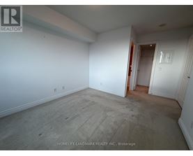 A room with white walls and a wooden floor is empty and waiting to be furnished.
