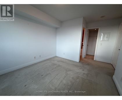 A room with white walls and a wooden floor is empty and waiting to be furnished.
