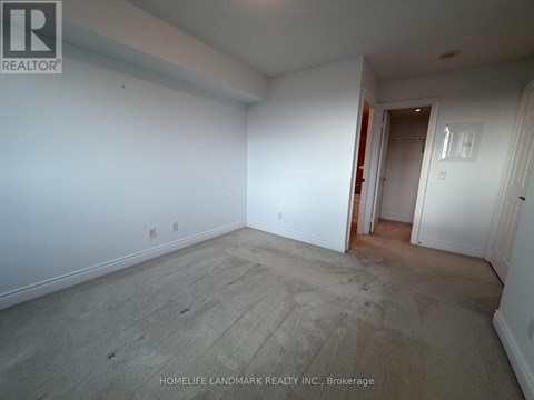 A room with white walls and a wooden floor is empty and waiting to be furnished.