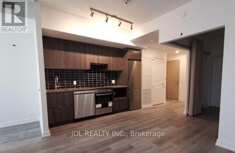 A kitchen area with wooden cabinets and a countertop.