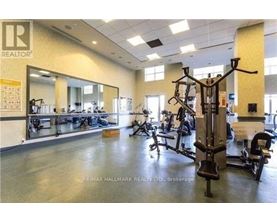 A gym with a variety of equipment including a squat rack.