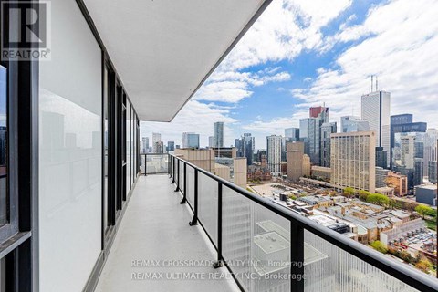 A balcony with a view of a city skyline.
