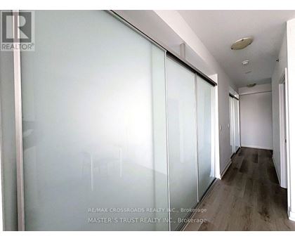 A long hallway with a glass wall on the left side.