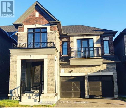 A house with a balcony and a garage door.