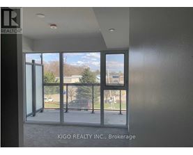 A room with a view of a parking lot through a glass door.