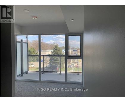 A room with a view of a parking lot through a glass door.