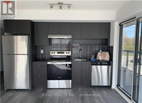 A modern kitchen with a stainless steel refrigerator and dishwasher.