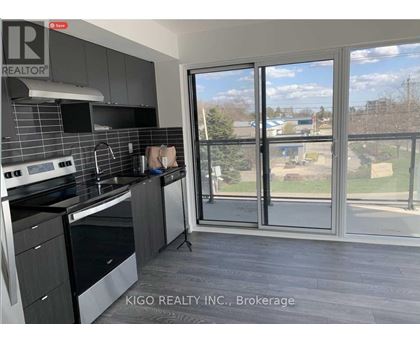 A kitchen with a large window overlooking a grassy area.